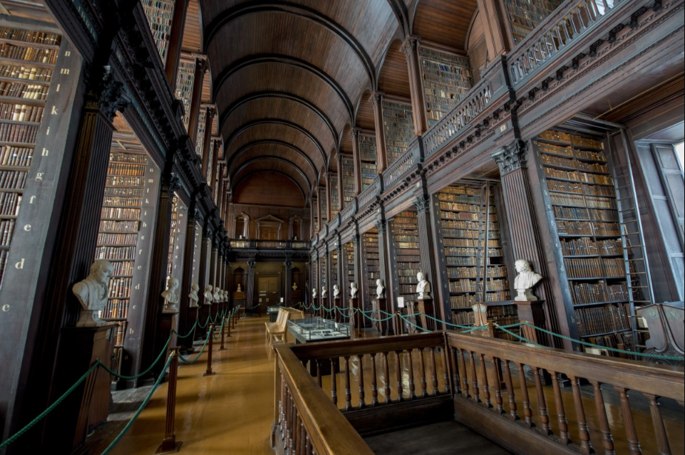 Corredor com arcos de madeira escurada biblioteca da Trinity College. Imagem ilustrativa texto bibliotecas mais bonitas do mundo.